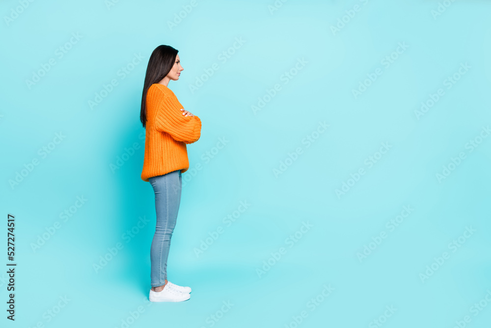 Full size profile photo of charming positive lady crossed arms look empty space isolated on teal color background Full size profile photo of charming positive lady crossed arms look empty space isolated on teal color background