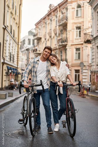 Smiling couple with bicycles spend time together