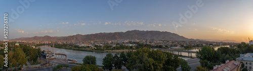 Scenic cityscape panorama on Khujand city and Syr Daria river with mountain background at sunrise, Sughd region, Tajikistan