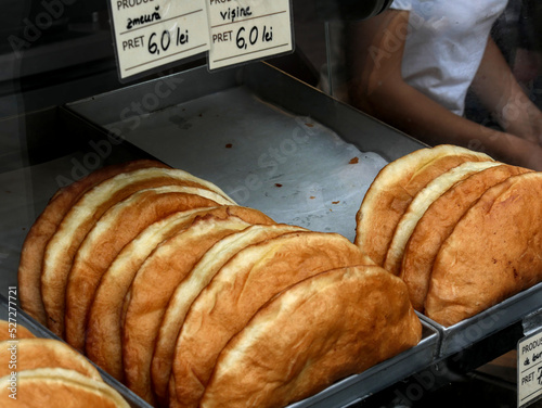 Romanian doughnuts called gogosi on a stall. The price is indicated on signs at the top of the picture. photo