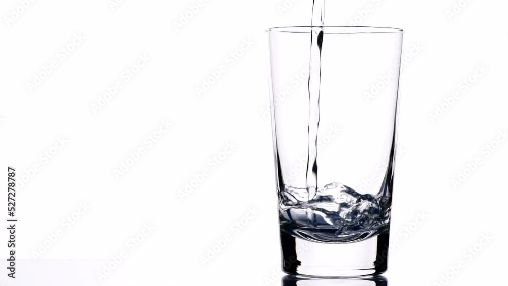 Fresh clean drink water in glass, Pouring pure drinking water into clear glass, splash out isolated on white background, slow motion. Concept of Drink Water, Flow, Healthy, Life, Nature, Transparent