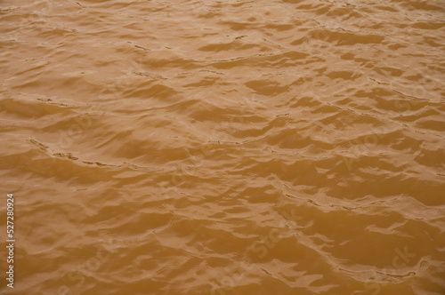 Background lake surface ferrous brown water from coal mining pit water eternity burdens