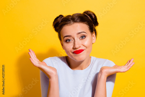 Photo of young negative mood female have argument with person shrug shoulders isolated on yellow color background