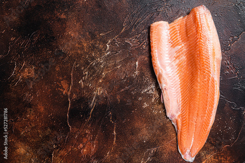 Fresh raw salmon fish fillet for steaks. Dark background. Top view. Copy space