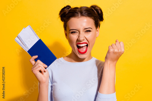 Photo of cheerful lady screaming fist up hold visa resort tickets lottery win isolated shine color background