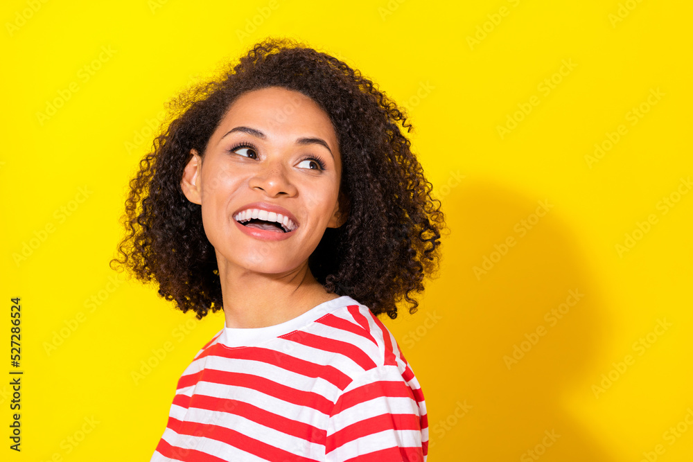 Profile photo of brunette impressed lady look empty space wear red striped t-shirt isolated on bright yellow color background Profile photo of brunette impressed lady look empty space wear red striped t-shirt isolated on bright yellow color background