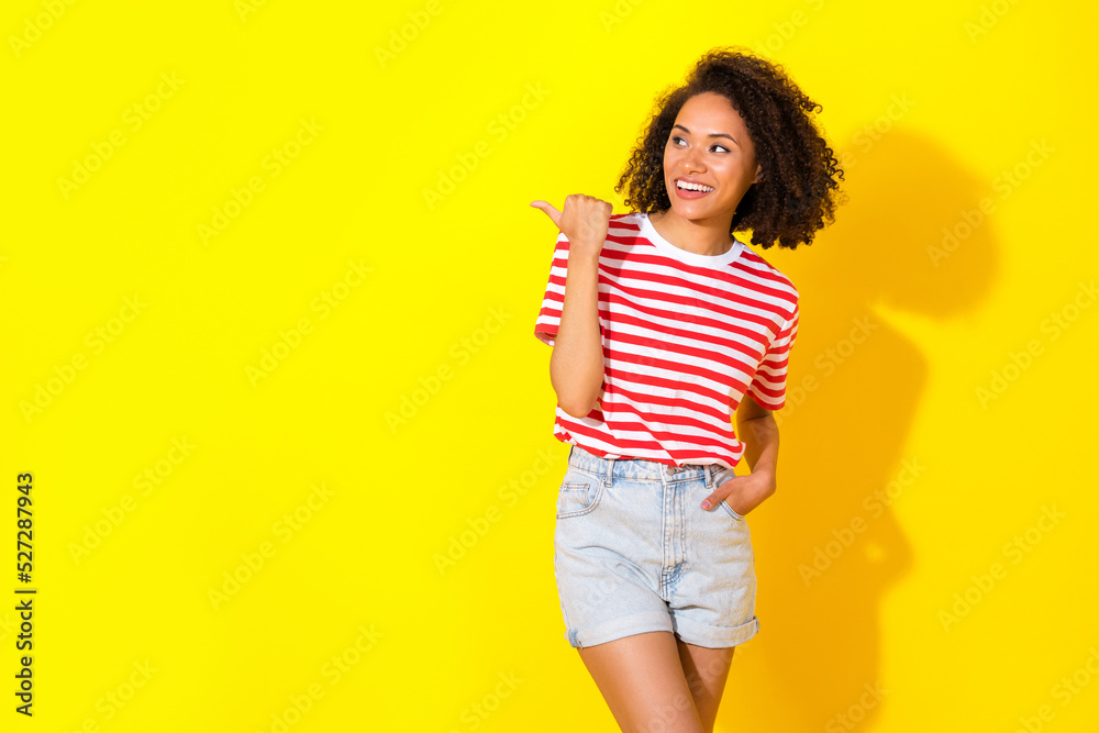 Portrait of young attractive pretty womant pointing finger empty space new coffee shop isolated on yellow color background Portrait of young attractive pretty womant pointing finger empty space new coffee shop isolated on yellow color background