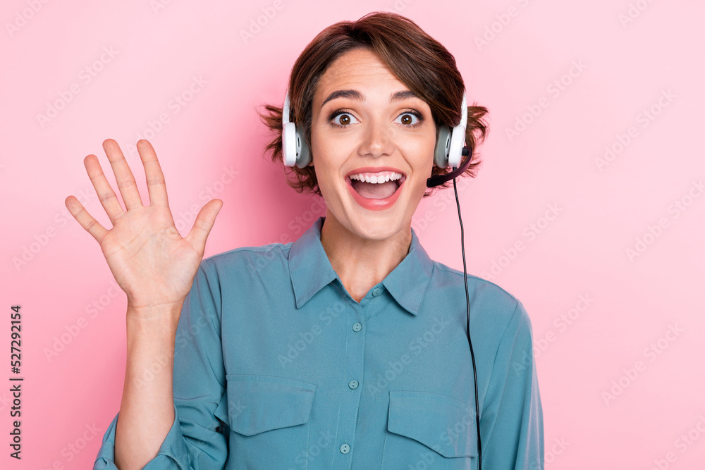 Photo portrait of attractive young girl raise hand greet new customer headset wear stylish blue outfit isolated on pink color background - obrazy, fototapety, plakaty 