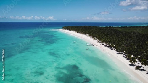 panoramic aerial view of paradisiacal caribbean beach in punta cana in dominican republic with blue sky, turquoise sea and white sand beach photo