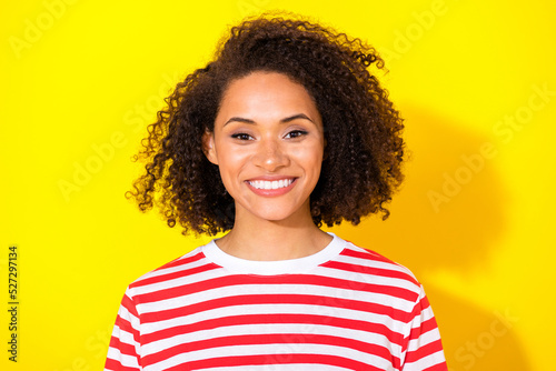 Closeup photo of young smiling toothy girl after whitening looking you isolated on yellow color background © deagreez
