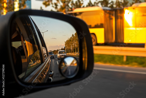 reflection of a traffic jam in the right car mirror on a sunny day in the city. Traffic