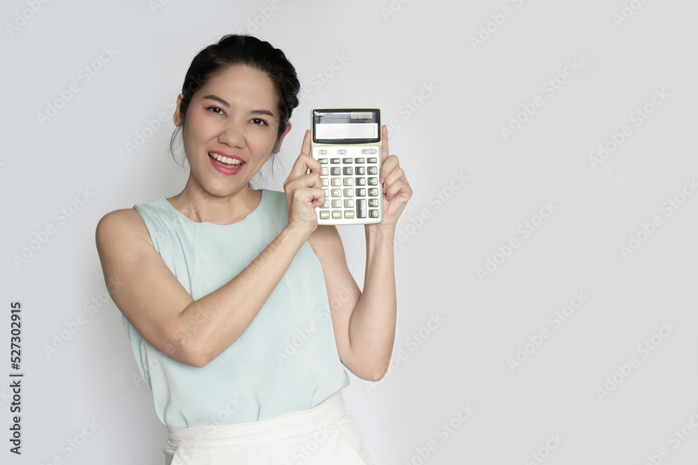 Asian beautiful woman hold calculator with smiling. Save and finance concept. Asian beautiful woman hold calculator with smiling. Save and finance concept.