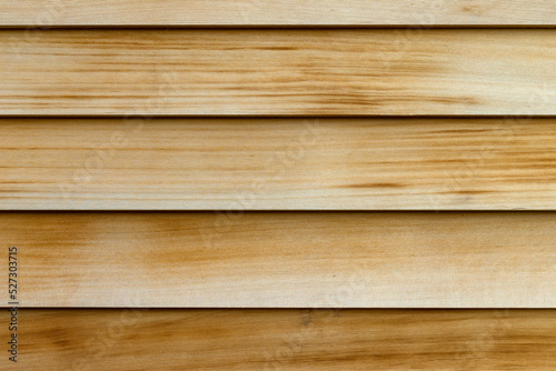 Horizontal rows of cedar wood siding as an exterior wall close view