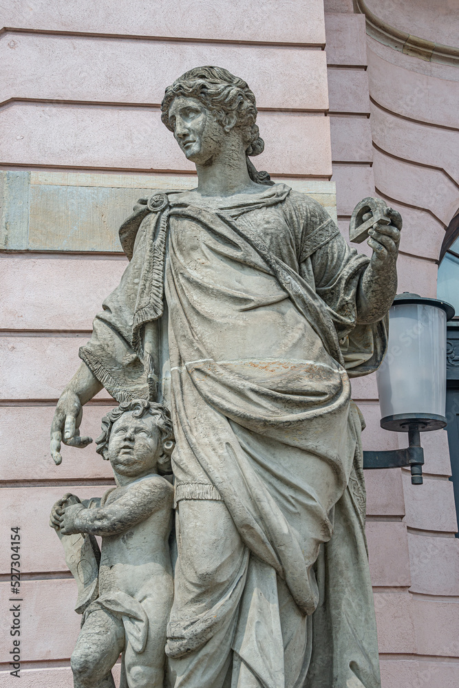 Closeup statue view of a Roman scholar woman teaching a child as angel near Berlin Cathedral and Unter den Linden street in historical and museum downtown of Berlin, Germany.