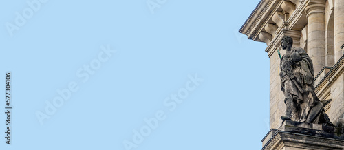 Photography Banner with an old statue of Roman soldier with helmet and spear at the wall of
