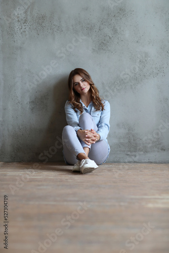 Happy friendly woman posing indoor at home in casual clothes. Lifestyle female portrait at home.