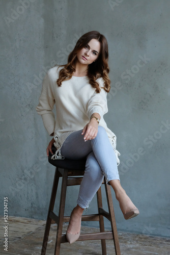 Happy friendly woman posing indoor at home in casual clothes. Lifestyle female portrait at home.