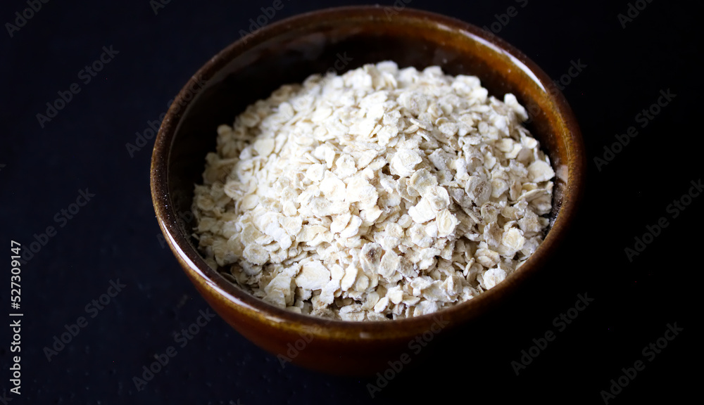 oatmeal in a brown bowl with dark background oatmeal in a brown bowl with dark background