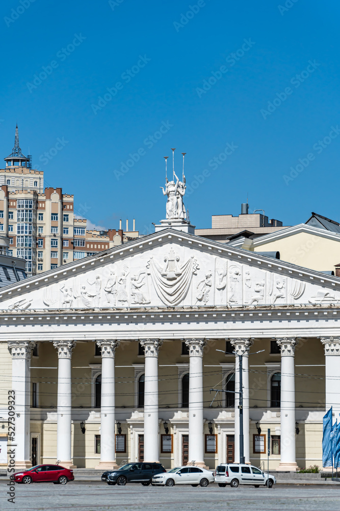 The building of State Opera and Ballet Theatre in Voronezh city. White facade with monumental columns of historic building in classical style. Voronezh, Russia - July 30, 2022