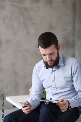 Young stressed handsome businessman working in office. 