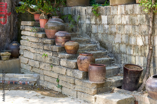 Stepped fence decorated with clay pots in the park