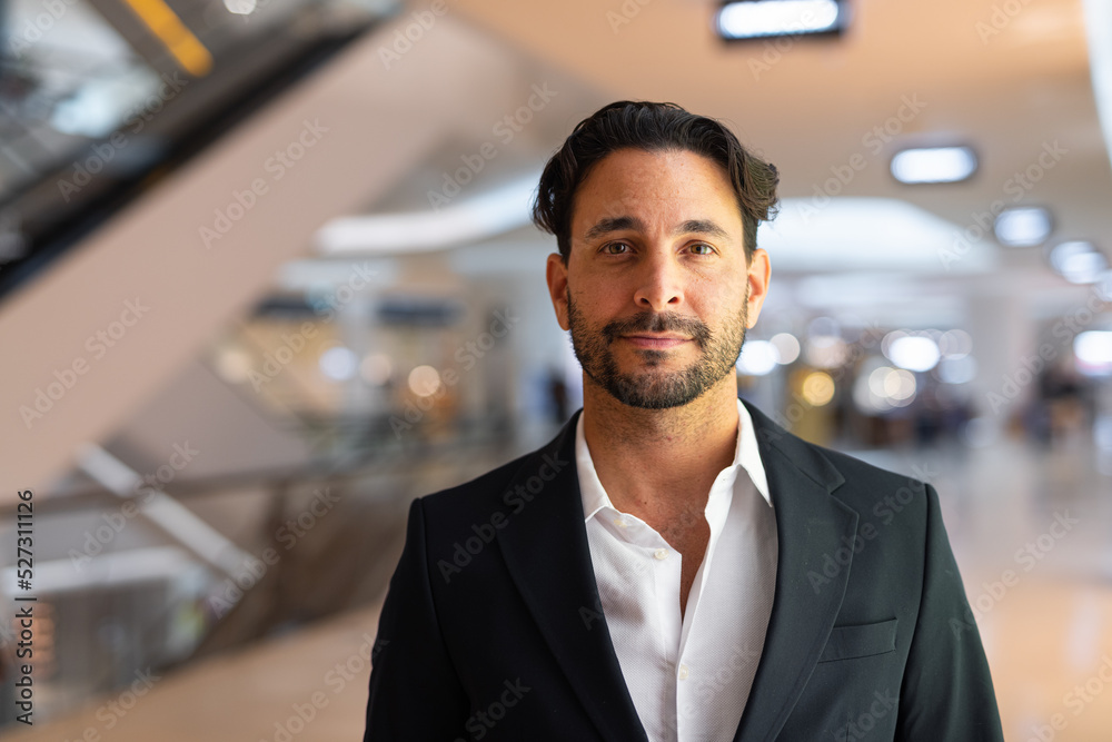 Portrait of happy handsome Hispanic businessman at city Portrait of happy handsome Hispanic businessman at city