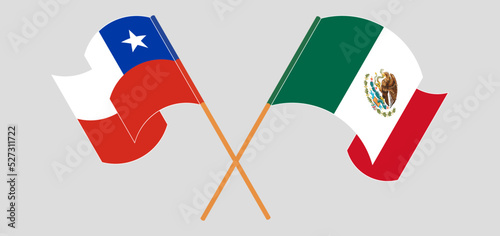Crossed and waving flags of Chile and Mexico