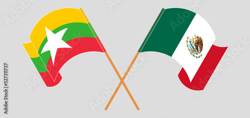 Crossed and waving flags of Myanmar and Mexico