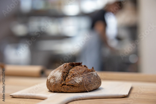 Baker carrying a tray of freshly baked bread