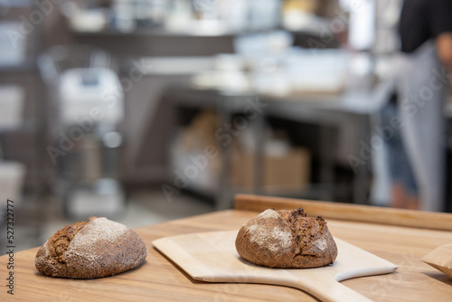 Baker carrying a tray of freshly baked bread