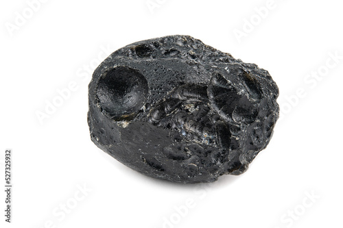 A piece of uncut black tektite with a rough surface
