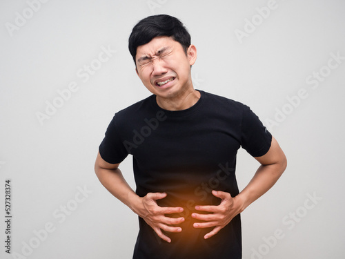 Asian man hold his belly feels very stomach ache isolated