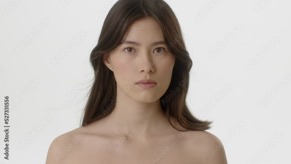 Beauty Woman face Portrait. Beautiful Spa model Girl with Perfect Fresh Clean Skin.Asian Female with Brunette hair looking at camera with calm look. Youth and Skin Care Concept. Isolated on a white Beauty Woman face Portrait. Beautiful Spa model Girl with Perfect Fresh Clean Skin.Asian Female with Brunette hair looking at camera with calm look. Youth and Skin Care Concept. Isolated on a white