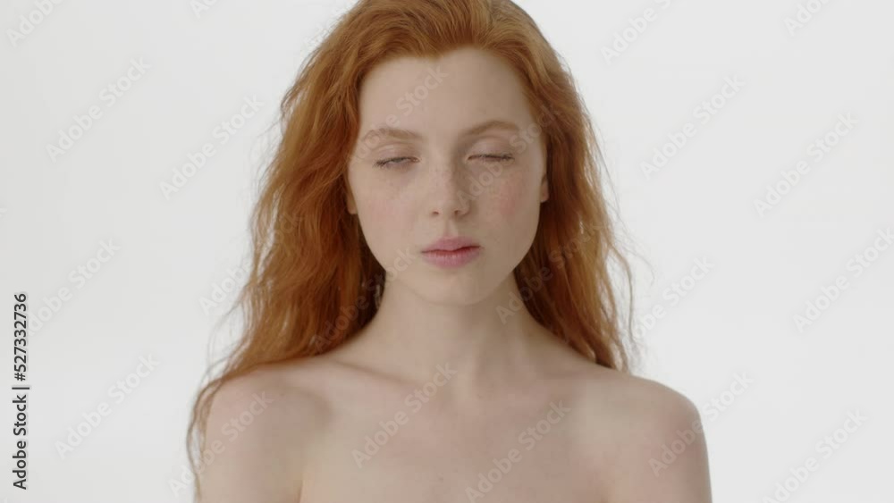 Beauty Woman face Portrait. Beautiful Spa model Girl with Perfect Fresh Clean Skin. Caucasian Female with Ginger haircut looking at camera with calm look. Youth and Skin Care Concept. Isolated on a