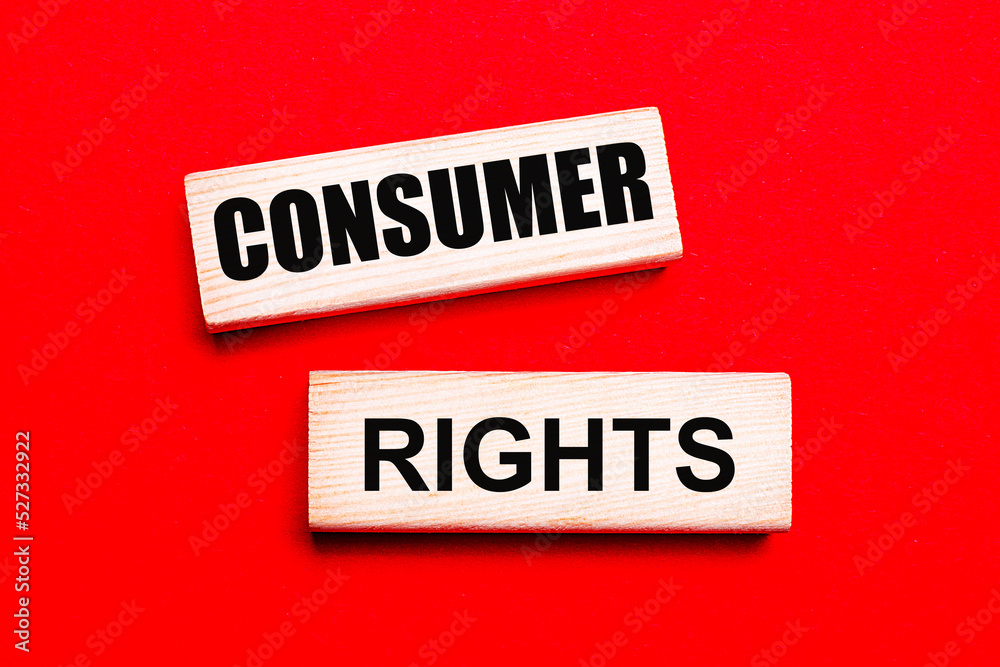 On a bright red background, there are two light wooden blocks with the text CONSUMER RIGHTS On a bright red background, there are two light wooden blocks with the text CONSUMER RIGHTS