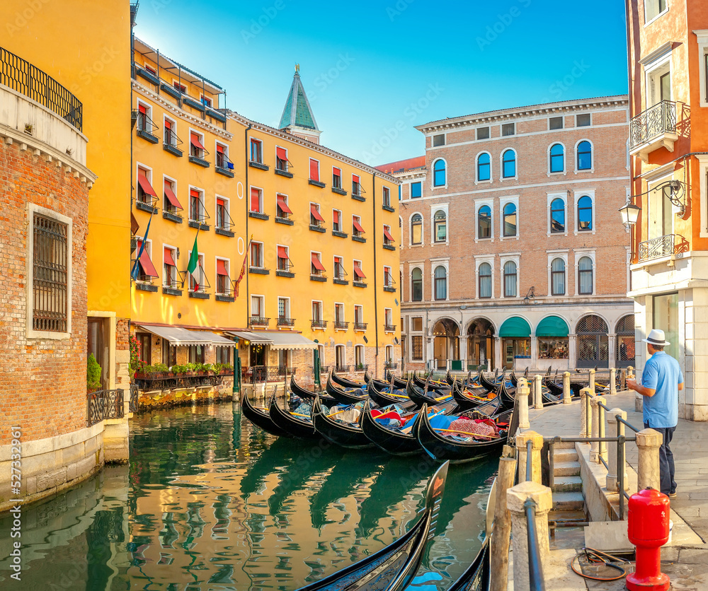 View on the narrow cozy streets of the canals with gondolas one of the symbols of Venice, Italy. Architecture and landmark of Venice.