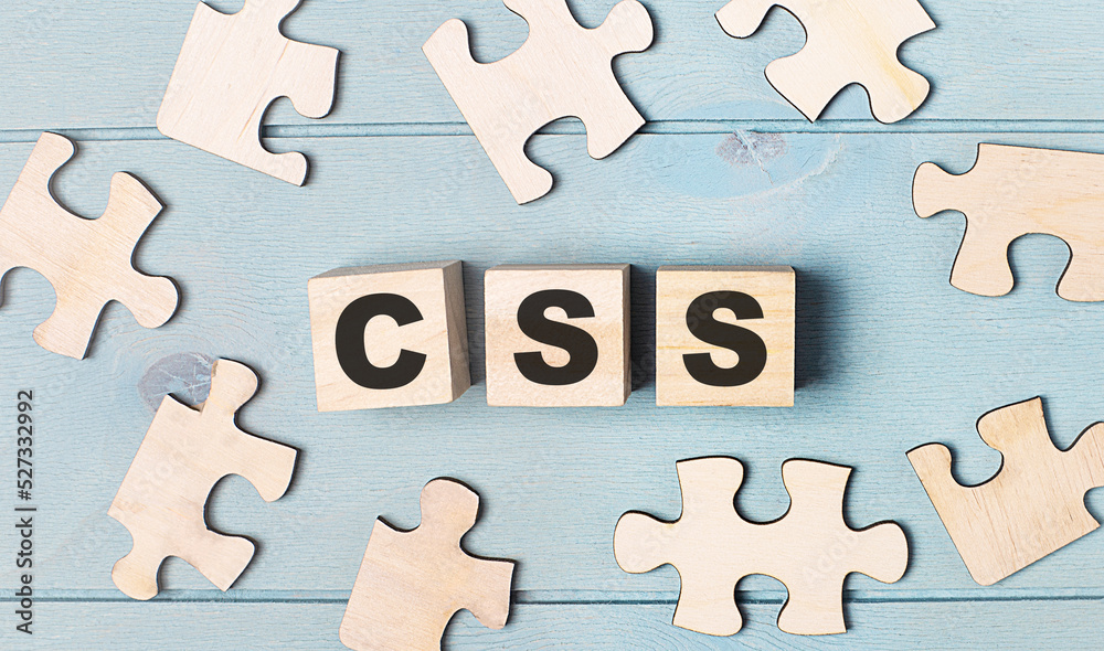 Blank puzzles and wooden cubes with the text CSS Cascading Style Sheets lie on a light blue background. Blank puzzles and wooden cubes with the text CSS Cascading Style Sheets lie on a light blue background.