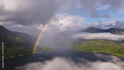 Drone footage of rainbow in clouds in Scottish Highlands landscape