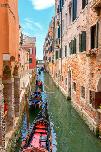 View on the narrow cozy streets of the canals with gondolas one of the symbols of Venice, Italy. Architecture and landmark of Venice.