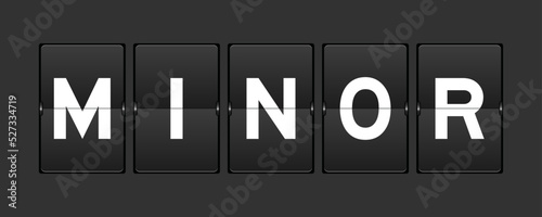 Black color analog flip board with word minor on gray background