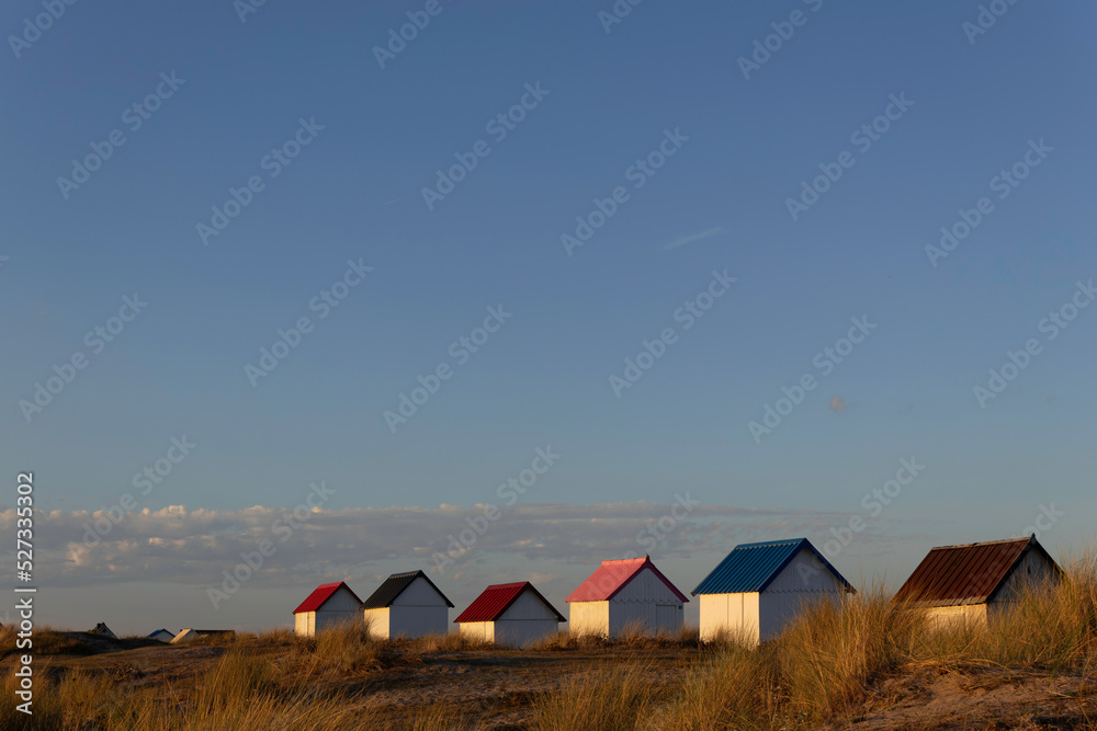 Beach cabins in Gouville sur Mer, Manche, Normandy, France in various lights