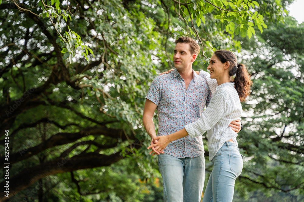 Young couple having fun in the moment of love in the park. Love and tenderness, Romantic man playing guitar to his girlfriend, lifestyle concept Young couple having fun in the moment of love in the park. Love and tenderness, Romantic man playing guitar to his girlfriend, lifestyle concept