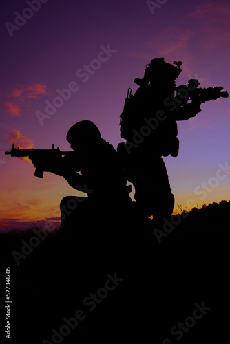 Two soldiers in a field at sunset
