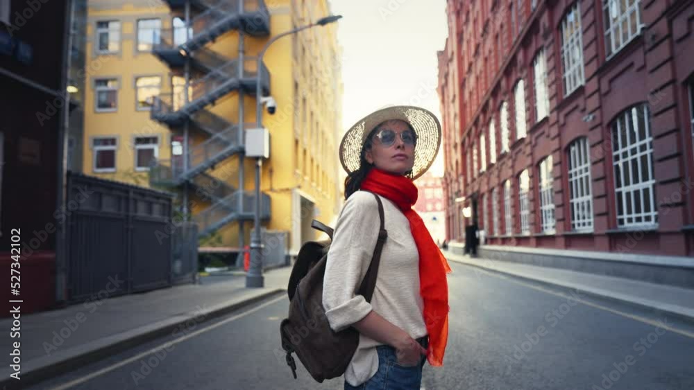 Young female tourist in a hat walking in the city Young female tourist in a hat walking in the city