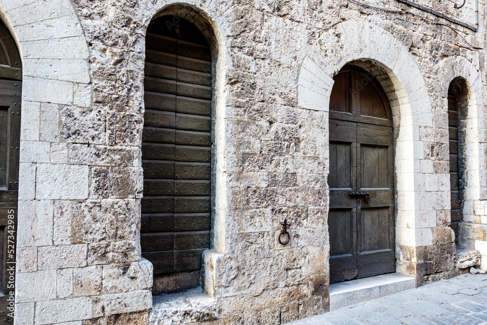 Old wooden door in a medieval building in Gubbio, Umbria, Italy, Europe