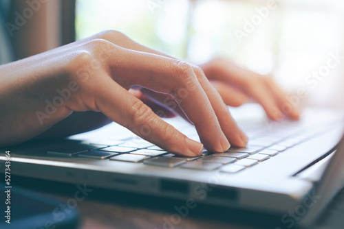 close up of female hand touching keyboard,using laptop at home