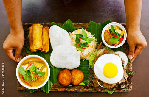 The Khmer tasting platter.  The Khmer platter features a sampling of Cambodian specialties like fish cakes, spring rolls, fish amok, curry, fried rice, and beef lok lok with egg. Siem Reap, Cambodia. photo