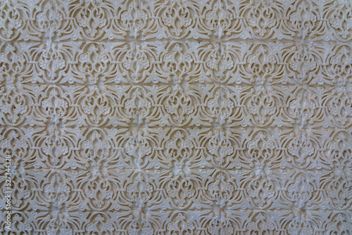 Closeup of beautiful traditional floral design in white stucco on the exterior wall of ancient mausoleum, Istaravshan, Sughd region, Tajikistan 