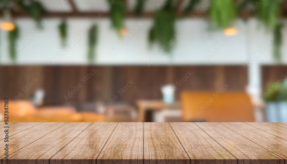 Empty wooden table top with lights bokeh on blur restaurant background. Empty wooden table top with lights bokeh on blur restaurant background.