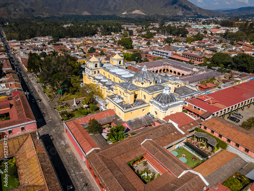 Beautiful aerial cinematic footage of the Antigua City in Guatemala, Its yellow church, the Santa Catalina Arch and the Acatenango Volcano © Gian